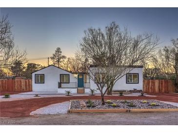 Charming single story home with a desert landscaped front yard and accent lighting at 1731 Sherwin Ln, Las Vegas, NV 89156