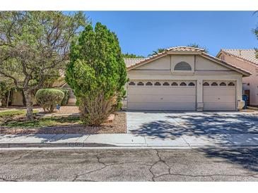 Charming single-story home featuring a three-car garage and mature trees providing shade at 1905 Dakota Hills Ave, Las Vegas, NV 89123