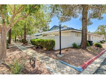 Charming single-story home with well-maintained landscaping and mature trees, showcasing a peaceful residential setting at 2028 Bavington Dr # A, Las Vegas, NV 89108