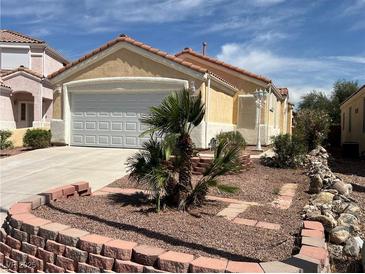 Charming single-story home with a well-maintained front yard and attached two-car garage at 2694 Hillgrass Rd, Las Vegas, NV 89123