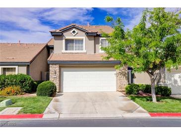 Charming two-story home featuring a two-car garage, well-maintained lawn and stone veneer accents at 602 Painted Cloud Pl, Las Vegas, NV 89144