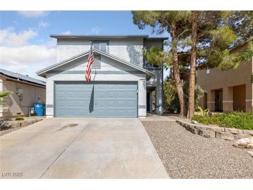Charming two-story home featuring a well-maintained front yard and attached two-car garage at 823 Schooner Dr, Henderson, NV 89015