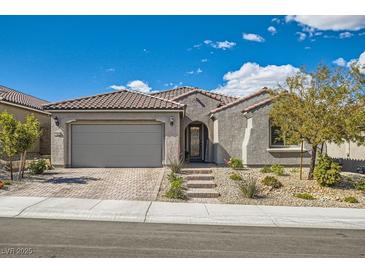 Charming single story home with a tile roof, low maintenance yard and a two car garage at 10456 Skye Arroyo Ave, Las Vegas, NV 89166