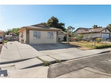 Charming single-story home featuring a spacious driveway and well-maintained front yard under a clear blue sky at 1105 Declaration Dr, Las Vegas, NV 89110