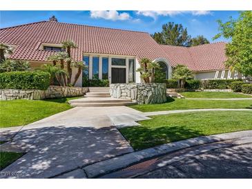 Stunning home featuring a red tile roof, well-manicured lawn, and attractive stone accents at 13 Dovetail Cir, Henderson, NV 89014