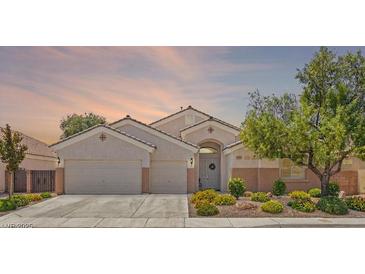 Charming single-story home with a three-car garage, well-maintained landscaping, and inviting curb appeal at 2025 Dakota Lodge Ave, Las Vegas, NV 89123