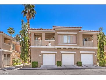 Well-maintained condo exterior with private garages, balconies, and lush landscaping in a desirable community at 251 S Green Valley Pkwy # 1421, Henderson, NV 89012
