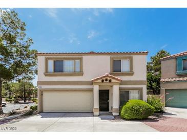 Inviting two-story home featuring a two-car garage, neutral stucco, and well-maintained landscaping at 3209 Cheltenham St, Las Vegas, NV 89129
