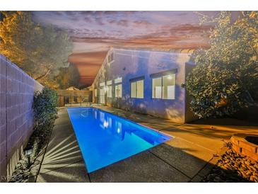 An inviting backyard featuring a private pool, lush landscaping, and a serene setting perfect for relaxation and entertainment at 4065 Genoa Dr, Las Vegas, NV 89141
