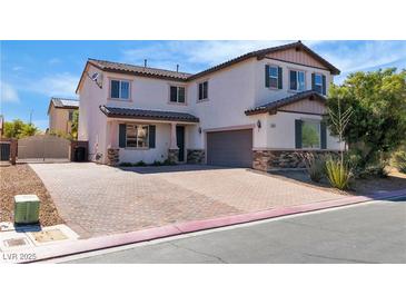Charming two-story home featuring a brick driveway and meticulously maintained landscaping at 5425 Pride Mountain St, North Las Vegas, NV 89031