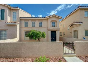 Inviting two-story home features a secure front yard, desert landscaping, and a cozy entrance at 56 Belle Ridge Ave, Las Vegas, NV 89123