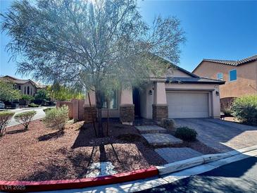 Charming single-story home with desert landscaping, stone accents, and a two-car garage at 7035 Thistle Ridge St, Las Vegas, NV 89166