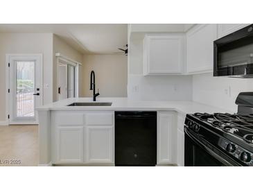 Modern kitchen featuring white cabinets, countertops, and black appliances at 9050 W Warm Springs Rd # 1117, Las Vegas, NV 89148