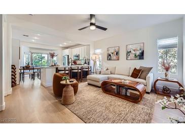 Bright, open living room flows into the kitchen and dining area, creating a welcoming and airy space at 2107 Desert Woods Dr, Henderson, NV 89012
