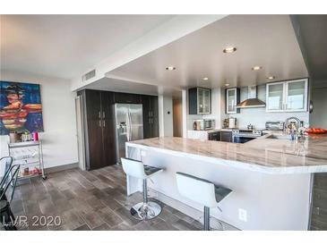 Modern kitchen featuring stainless steel appliances and marble countertops and sleek gray and white cabinetry at 3111 Bel Air Dr # 4B, Las Vegas, NV 89109