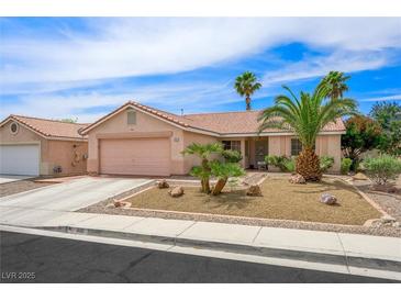 Charming single-story home with desert landscaping, mature palm trees and two-car garage at 3121 Fontana Colony Ct, North Las Vegas, NV 89031