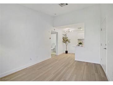 Bright living room boasts sleek, light wood floors and neutral walls, creating an airy and inviting space at 5171 Lindell Rd # 201, Las Vegas, NV 89118