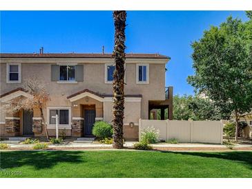 Charming two-story townhome with a well-manicured lawn and cozy front porch at 67 Dow Jones St # 2, Henderson, NV 89074