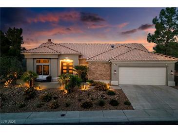 Charming single-story home boasts a well-manicured front yard, desert landscaping, and a warm, inviting ambiance at 2820 High Range Dr, Las Vegas, NV 89134