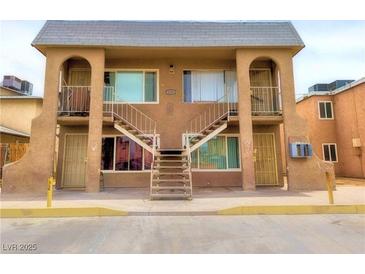 Two-story building features stairs to apartments, secure doors and windows, and a painted exterior at 3101 E Carey Ave, North Las Vegas, NV 89030