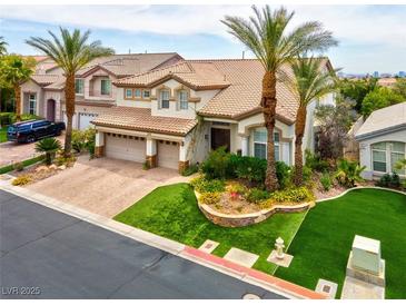 Beautiful two-story home with a well-manicured front yard, palm trees, and a three-car garage at 4326 Spooner Lake Cir, Las Vegas, NV 89147