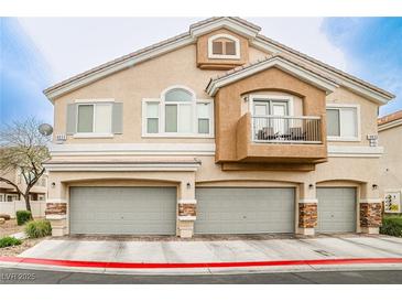 Inviting multi-level townhome featuring a private balcony and attached two-car garage at 4833 Straight Flush Dr # 103, Las Vegas, NV 89122