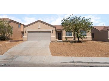 Charming single-story home featuring a low maintenance desert landscape and attached two-car garage at 6140 Passionate Ct, North Las Vegas, NV 89031