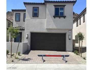 Charming two-story home with a two-car garage and well-maintained landscaping at 64 Via Montoro, Henderson, NV 89011
