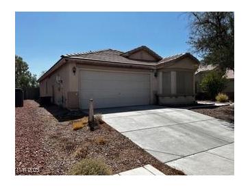Charming single-story home with a two-car garage, low-maintenance desert landscaping, and a covered front porch at 7850 Flagler St, Las Vegas, NV 89139