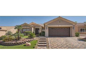 Charming home featuring a well-manicured front yard with desert landscaping and a paved driveway at 10013 Hunter Springs Dr, Las Vegas, NV 89134