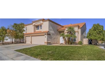 Charming two-story home with a two-car garage, well-maintained lawn, and desert landscaping at 2732 Dune Cove Rd, Las Vegas, NV 89117