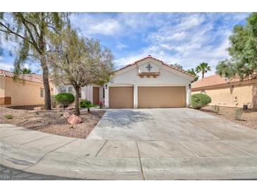Charming single-story home featuring a two-car garage and desert landscaping in a tranquil neighborhood at 4176 Demoline Cir, Las Vegas, NV 89141