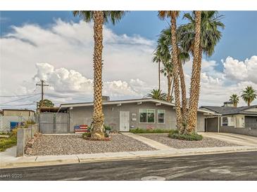 Charming single-story home with desert landscaping, palm trees, and a welcoming front entrance at 5217 Champions Ave, Las Vegas, NV 89142