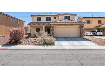 Charming two-story home with a tile roof, stone accents, and a well-manicured front yard at 6052 Puesta Del Sol St, North Las Vegas, NV 89081