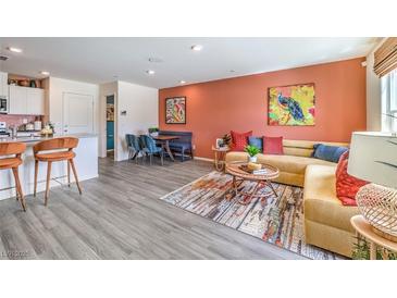 Bright living room showcases stylish decor, colorful accent wall, and lots of natural light at 7375 Hayes Harbor Ct # Lot 210, North Las Vegas, NV 89084
