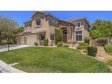 Charming two-story home with a well-manicured lawn, three car garage, and stone accents at 8106 Eagle Clan Ct, Las Vegas, NV 89131