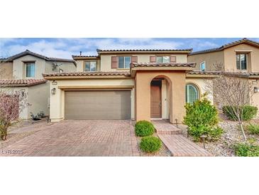 Charming two-story home featuring a brick driveway, arched entry and tidy front landscaping at 12816 Alcores St, Las Vegas, NV 89141