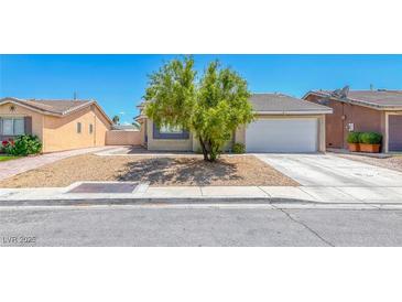 Charming single-story home with xeriscaped front yard and well-maintained curb appeal at 2103 Falcon Crest Ave, North Las Vegas, NV 89031