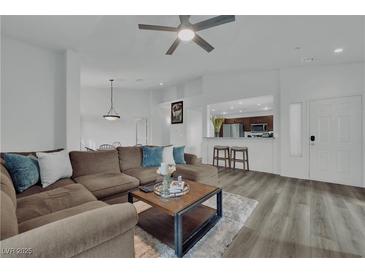 Spacious living room featuring an open floor plan and modern hardwood flooring throughout at 2325 Windmill Pkwy # 1023, Henderson, NV 89074
