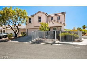 Inviting two-story home with neutral stucco, tile roof, well-kept front yard, and decorative white metal fence at 3954 Crystal Trip Ct, Las Vegas, NV 89129