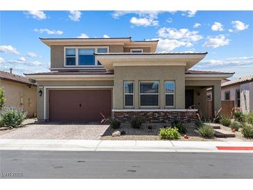 Two-story home boasting desert landscaping, a brick-paved driveway, and a two-car garage at 417 Honeybrush Ave, Henderson, NV 89011