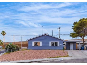 Charming single-story home showcasing a simplistic desert landscape and a driveway with covered parking at 4629 San Cir, Las Vegas, NV 89120