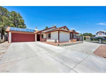 Charming single-story home featuring solar panels, a spacious driveway, and an attached two-car garage at 5876 Tippin Dr, Las Vegas, NV 89130