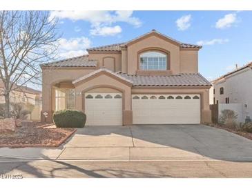 Charming two-story home featuring a three-car garage and well-maintained landscaping at 59 Desert Dawn Ln, Henderson, NV 89074