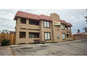 Two-story multi-Gathering building featuring a red tile roof and stucco exterior at 6996 Hopkins Dr, Las Vegas, NV 89156