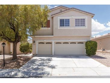 Inviting two-story home featuring a spacious three-car garage and well-maintained landscaping at 9029 Tumblewood Ave, Las Vegas, NV 89143
