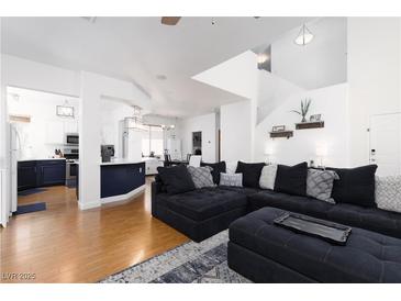 Bright living room with a contemporary design, featuring an oversized sectional and wood floors at 9029 Tumblewood Ave, Las Vegas, NV 89143