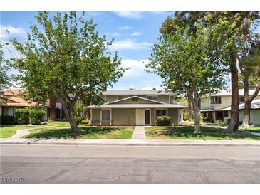 Charming home showcasing its well-maintained lawn and inviting facade nestled between mature trees at 1470 Elizabeth Ave # 1, Las Vegas, NV 89119