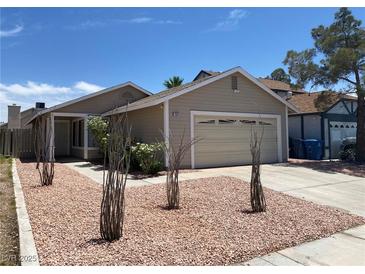Charming single story home showcasing desert landscaping and a two car garage at 1501 Wintergreen Dr, Las Vegas, NV 89128