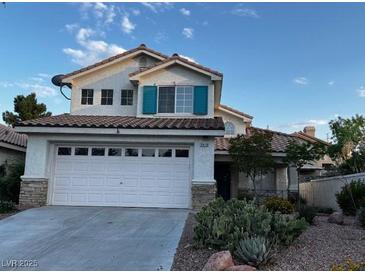 Charming two-story home featuring a two-car garage, tile roof, and landscaped front yard, offering both curb appeal and functionality at 2419 Pebble Springs Ct, Henderson, NV 89074